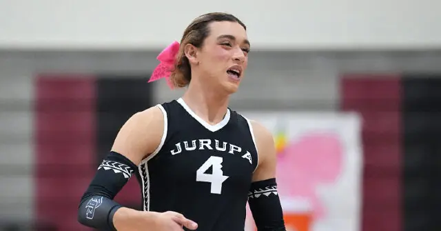 A volleyball player from Jurupa, wearing jersey number 4, is captured in action during a game.