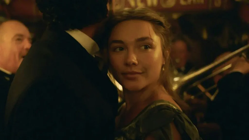 The image depicts a scene from a historical setting, featuring a woman in a period dress and a man in formal attire, with a band playing in the background.