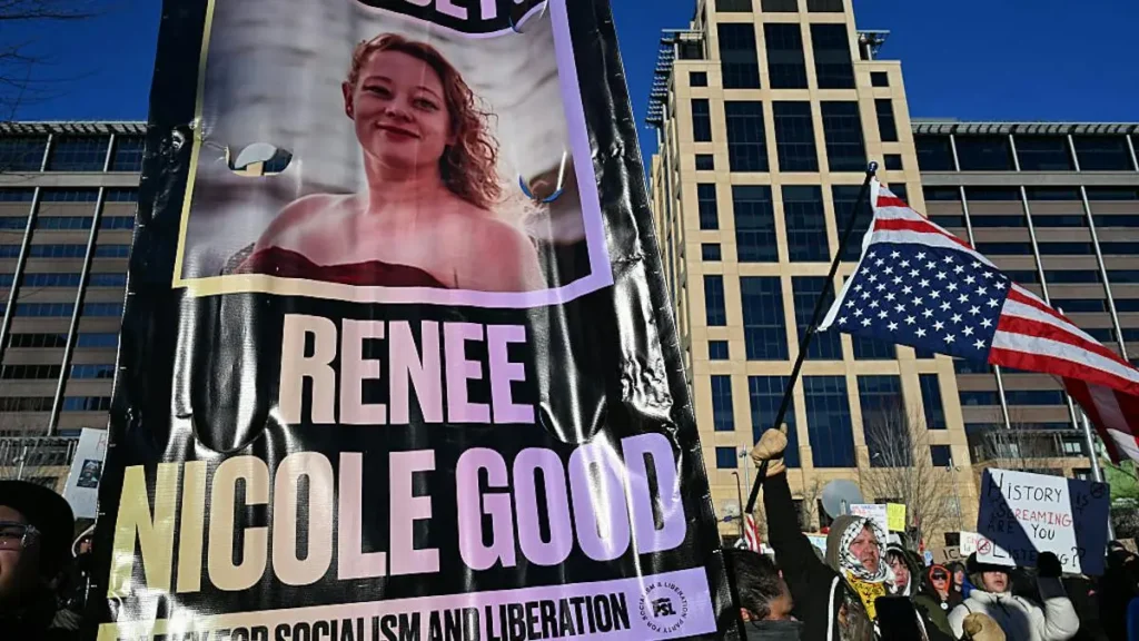 The image shows a protest banner featuring a photo of Renee Nicole Good, with the text "Renee Nicole Good" and "Fight for Socialism and Liberation," alongside a crowd holding signs and an American flag.