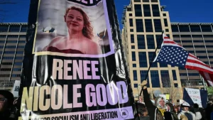 The image shows a protest banner featuring a photo of Renee Nicole Good, with the text "Renee Nicole Good" and "Fight for Socialism and Liberation," alongside a crowd holding signs and an American flag.