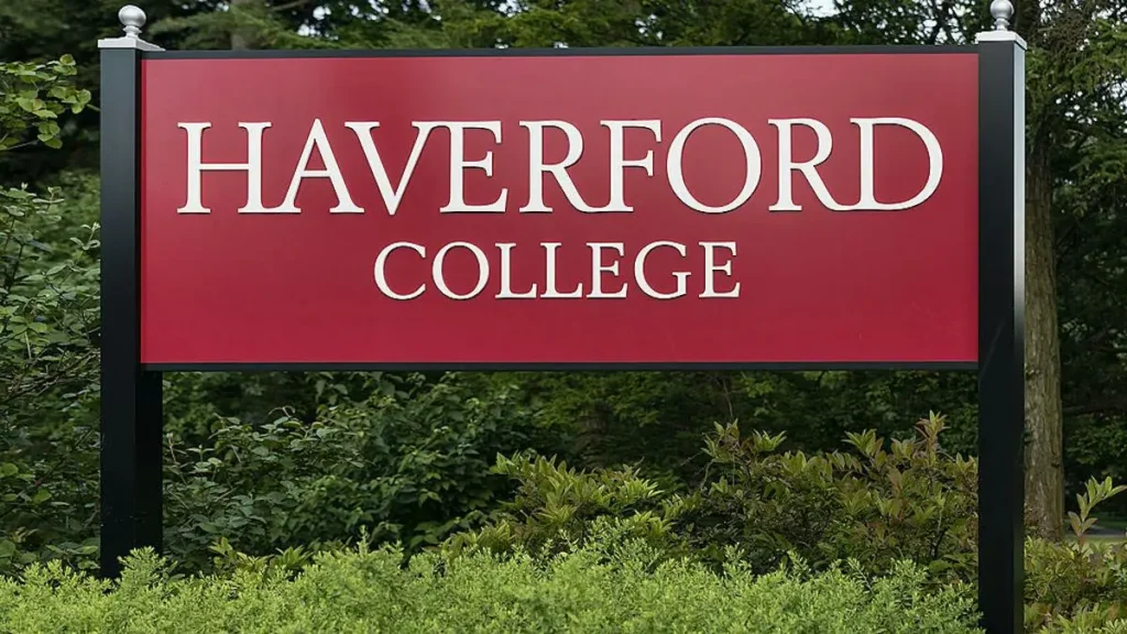 The image shows a sign for Haverford College, set against a backdrop of greenery.