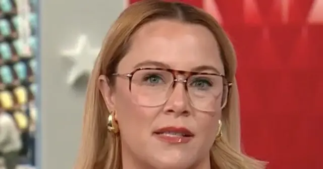 The image shows a person with long blonde hair wearing glasses and earrings, set against a red and white background.