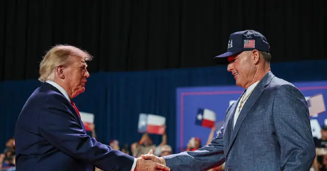 The image shows two individuals shaking hands at a political rally, with one person wearing a cap and the other in formal attire.