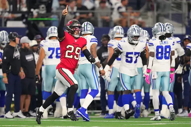 A Tampa Bay Buccaneers player celebrates on the field during a game against the Dallas Cowboys.